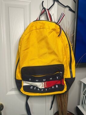 Vintage Tommy Hilfiger yellow backpack featuring a prominent bag logo!